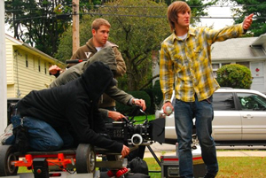 Todd Wiseman (plaid shirt) directs a dolly shot.