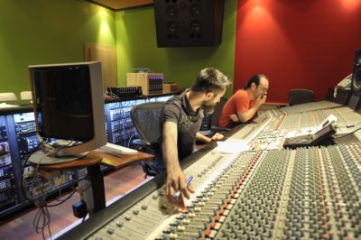 Roger Montejano (L) and Caco Refojo (R) in front of PKO Studios' SSL 9000J, auditioning acoustic guitar mic placements.