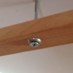 Lengths of wood screwed into the ceiling are a simple and inexpensive way to suspend acoustic panels from above.